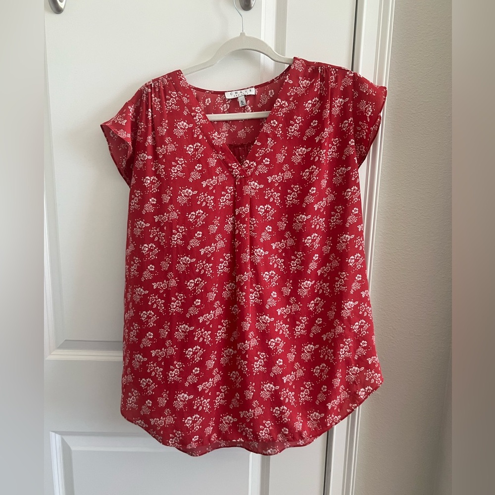 Pink short sleeve blouse with white flowers.